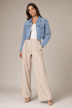 Load image into Gallery viewer, Embellished Light-Wash Denim Statement Jacket styled on model against a stone gray studio background