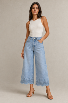Load image into Gallery viewer, light-blue-wide-leg-denim-pants-scalloped-lace-hem — stone gray editorial model three-quarter image
