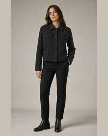 Load image into Gallery viewer, Model styling the longer black rhinestone trucker jacket, three-quarter view
