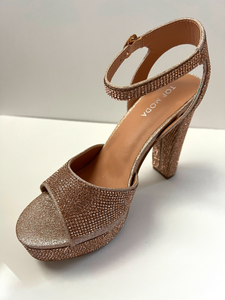 High heeled party and evening shoe with crystal embellishments. Open-toed sandal. Platform with ankle strap. Good for parties and formal occasions. Evening shoe. Party shoe. Comes in champagne color.
