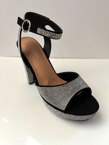 High heeled party and evening shoe with crystal embellishments. Open-toed sandal. Platform with ankle strap. Good for parties and formal occasions. Evening shoe. Party shoe. Comes in black color.