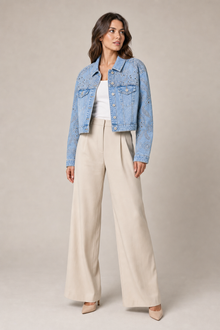 Load image into Gallery viewer, Embellished Light-Wash Denim Layering Jacket styled on model against a stone gray studio background
