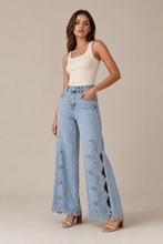 Load image into Gallery viewer, light-wash-eyelet-floral-cutout-wide-leg-jeans — stone gray editorial model three-quarter image

