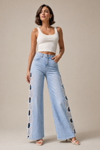 Load image into Gallery viewer, light-wash-distressed-ripped-wide-leg-jeans — stone gray editorial model three-quarter image
