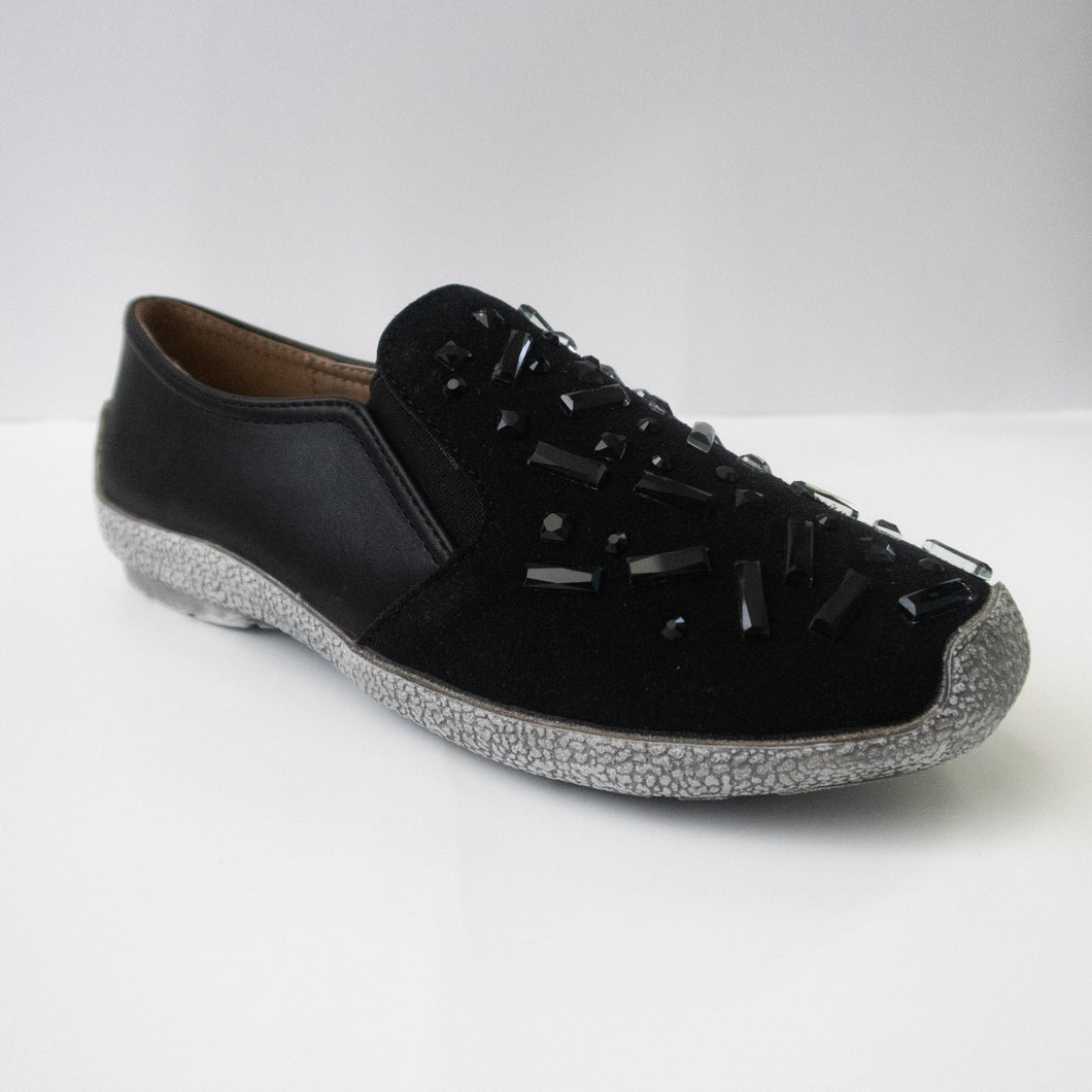 Black slip-on sneakers with black chunky crystals and a gray sole.