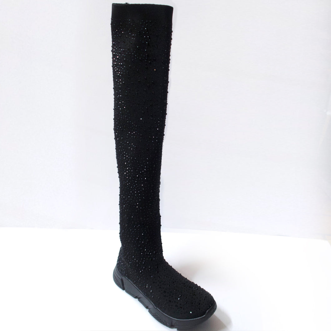Black knee-high sock sneaker boot hybrid with crystal embellishments. Stretchy sock-knit upper embellished with black crystals. Pull-on style. Black sneaker-like soles.