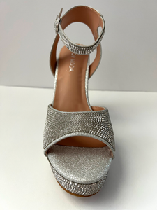 High heeled party and evening shoe with crystal embellishments. Open-toed sandal. Platform with ankle strap. Good for parties and formal occasions. Evening shoe. Party shoe. Comes in silver color.