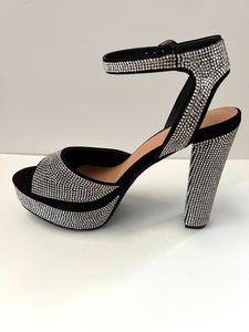High heeled party and evening shoe with crystal embellishments. Open-toed sandal. Platform with ankle strap. Good for parties and formal occasions. Evening shoe. Party shoe. Comes in black color.