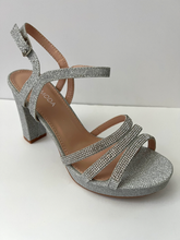 Load image into Gallery viewer, Glitter and crystal embellished platform sandal heels. Good for parties and formal occasions. Platform for additional support. Ankle strap to keep foot in place. Three decorative straps at front of shoe for decoration. Comes in gold, silver, and black. Silver color.
